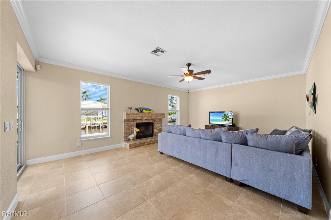 5025 Southwest 10th Avenue Cape Coral, FL 33914 - Photo 13 of 44 a living room with furniture and a fireplace