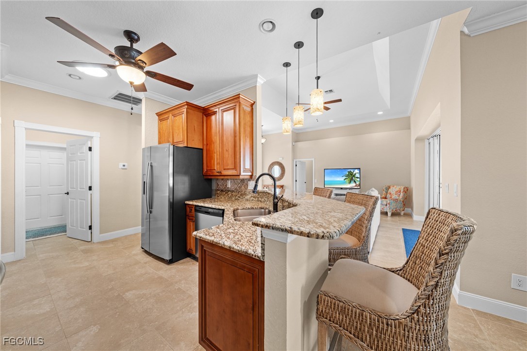 5025 Southwest 10th Avenue Cape Coral, FL 33914 - Photo 17 of 44 a very nice looking dining room with a table chairs and a ceiling fan