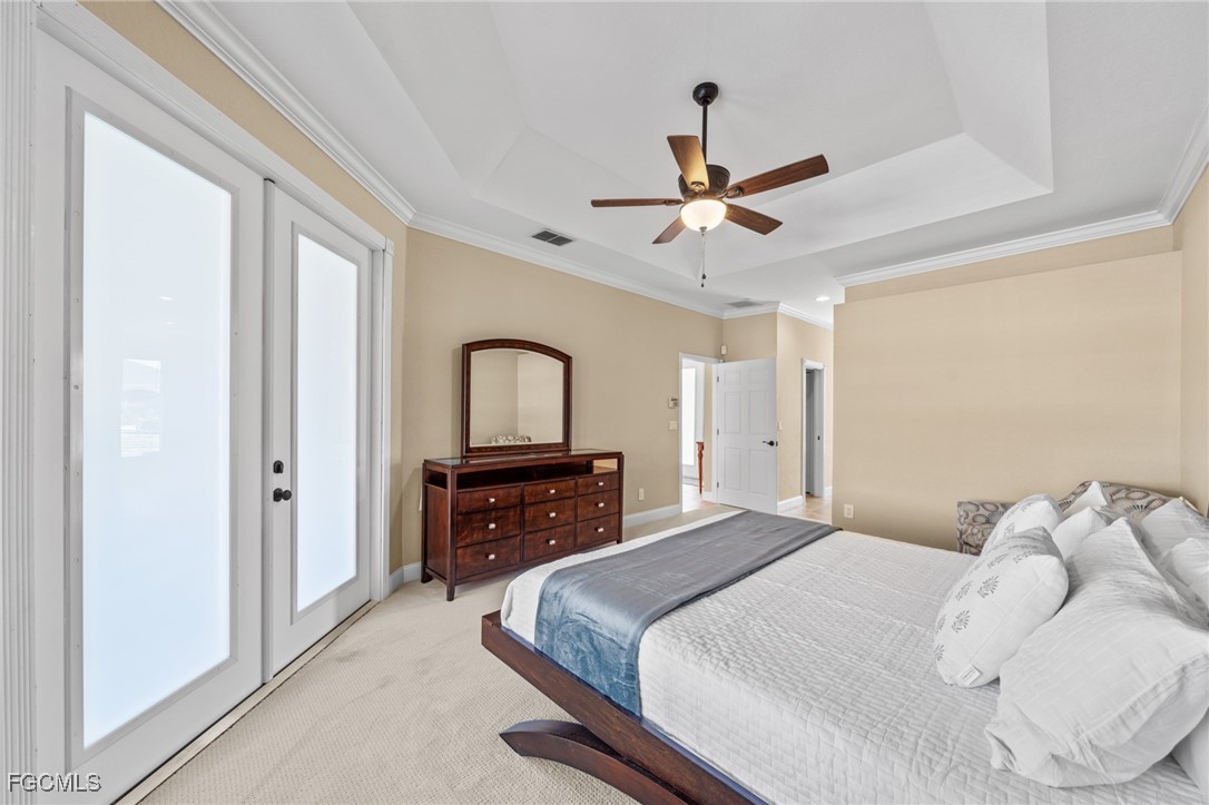 5025 Southwest 10th Avenue Cape Coral, FL 33914 - Photo 22 of 44 a bedroom with a bed and a chandelier