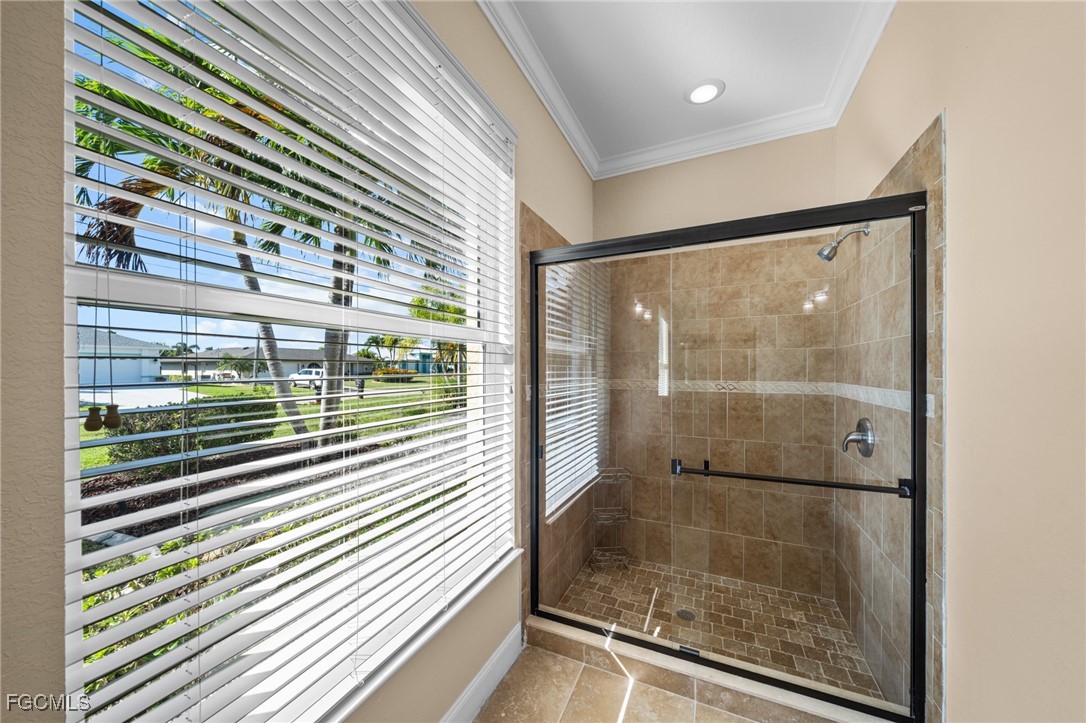 5025 Southwest 10th Avenue Cape Coral, FL 33914 - Photo 25 of 44 a bathroom with a glass door