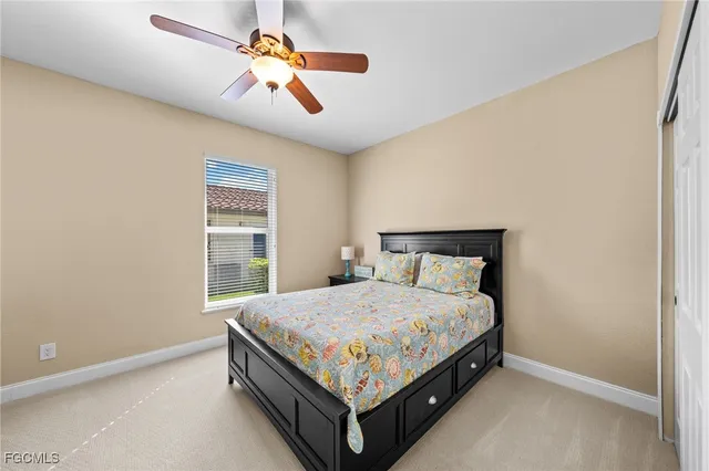 a bed sitting in a bedroom next to a window