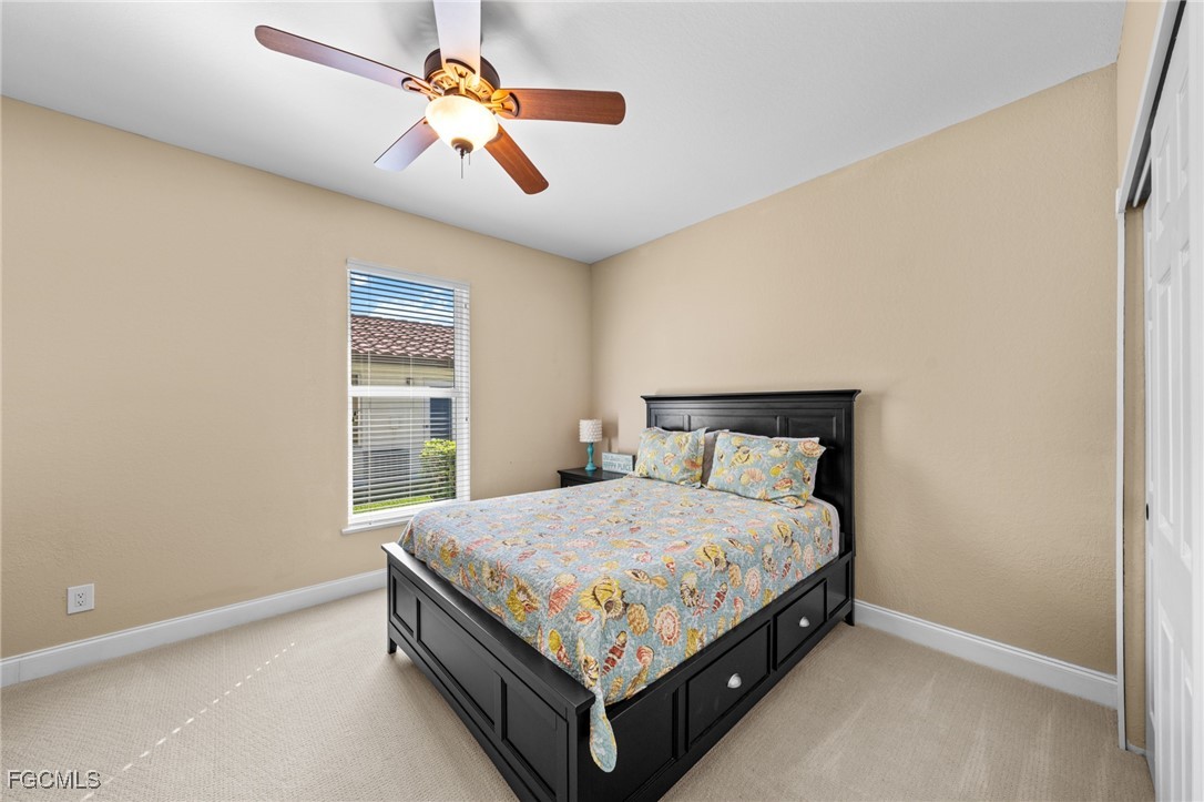 5025 Southwest 10th Avenue Cape Coral, FL 33914 - Photo 26 of 44 a bed sitting in a bedroom next to a window