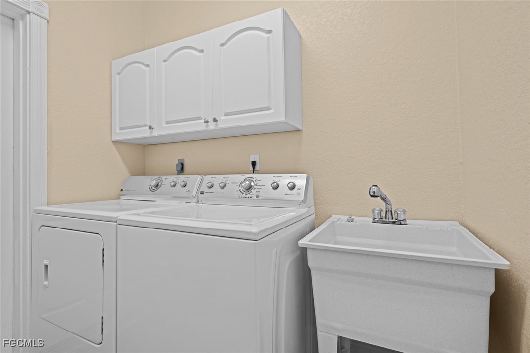 5025 Southwest 10th Avenue Cape Coral, FL 33914 - Photo 30 of 44 a utility room with sink dryer and washer