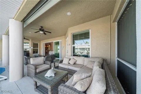 a front view of a house with porch and furniture