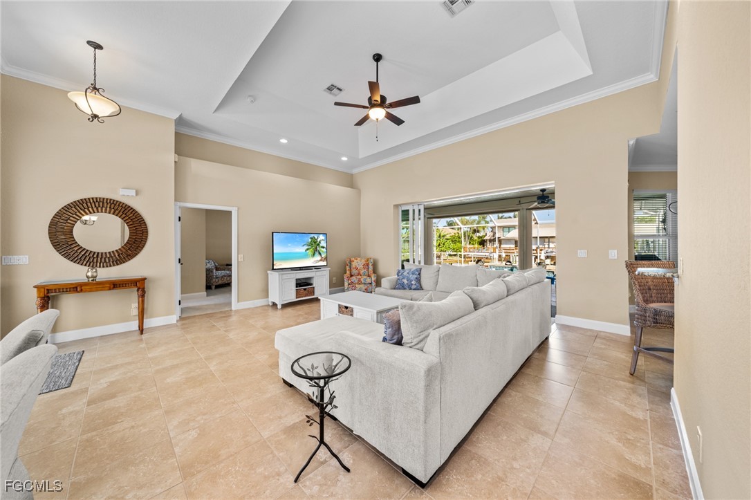 5025 Southwest 10th Avenue Cape Coral, FL 33914 - Photo 6 of 44 a living room with furniture and a table