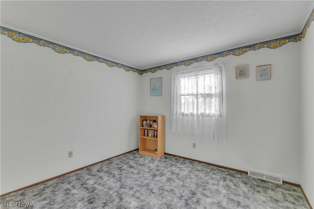 563 North Carpenter Road Brunswick, OH 44212 - Photo 25 of 45 Carpeted bedroom with baseboards and a textured ceiling