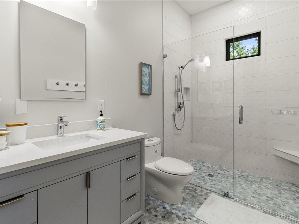 3937 West Shadow Creek Loop Lecanto, FL 34461 - Photo 22 of 65 a bathroom with a toilet a sink a mirror and shower