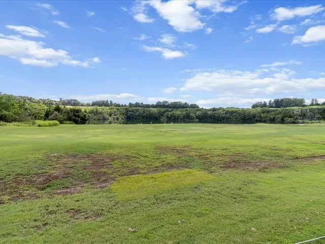 a dining room with furniture and a floor to ceiling window