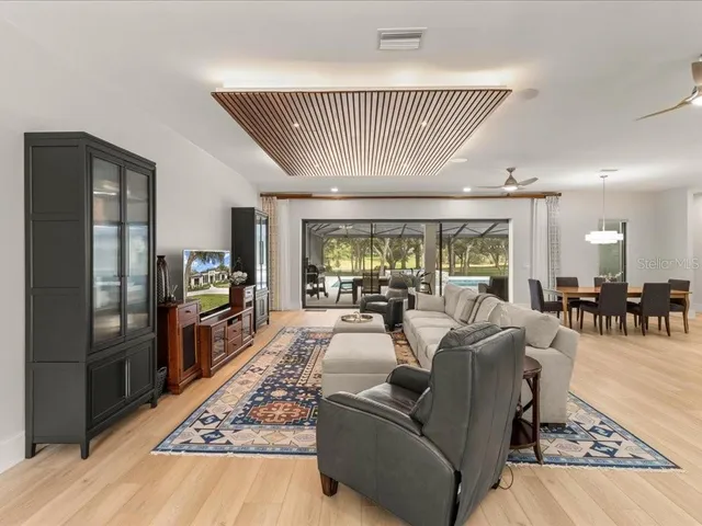 a large kitchen with kitchen island a sink appliances and a counter top space