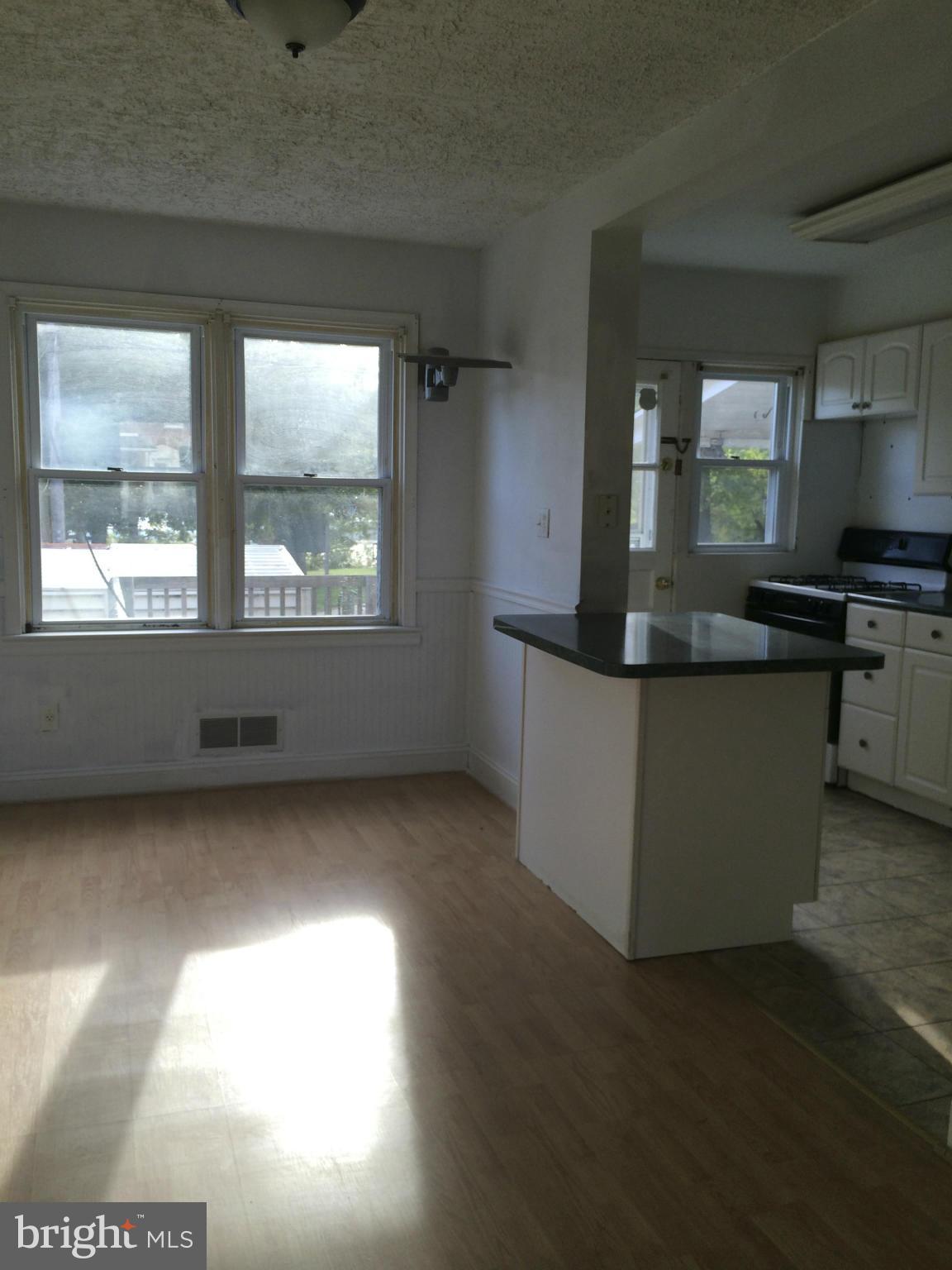 340 Grovethorn Road Baltimore, MD 21220 - Photo 2 of 17 an empty room with wooden floor and windows
