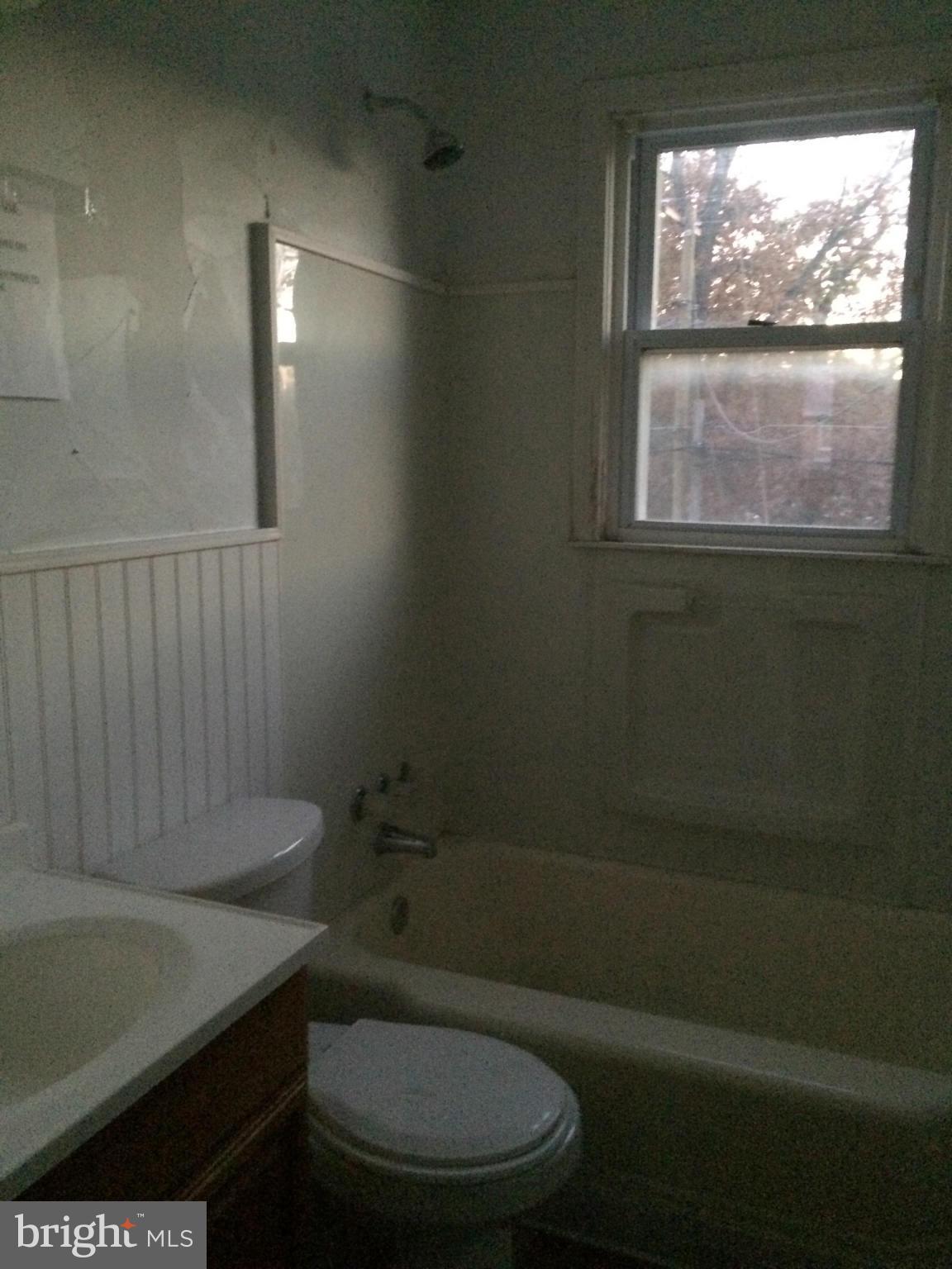 340 Grovethorn Road Baltimore, MD 21220 - Photo 17 of 17 a bathroom with a toilet a sink and window