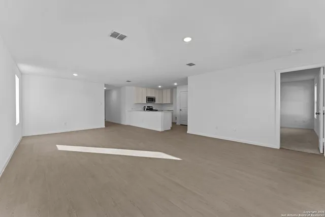 a view of a kitchen with a sink and a refrigerator