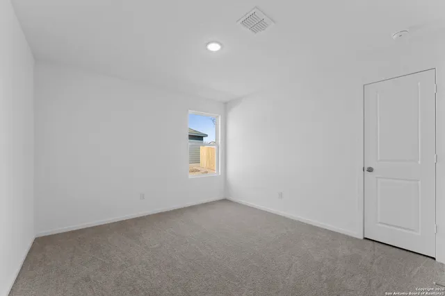 a view of kitchen with kitchen island white cabinets and stainless steel appliances