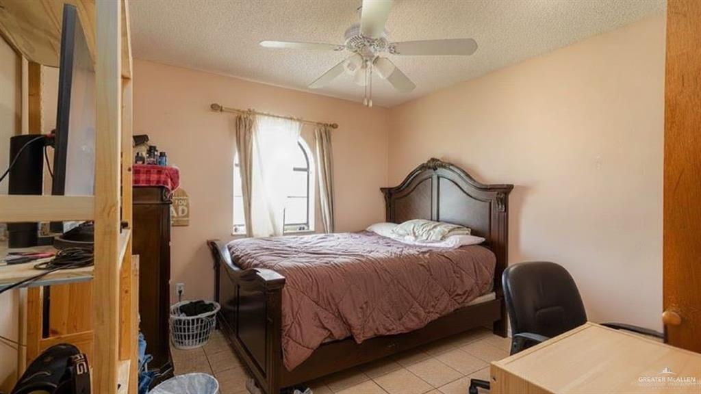 1409 Valencia Avenue Pharr, TX 78577 - Photo 8 of 11 a bedroom with a bed and a chair with the potted plant