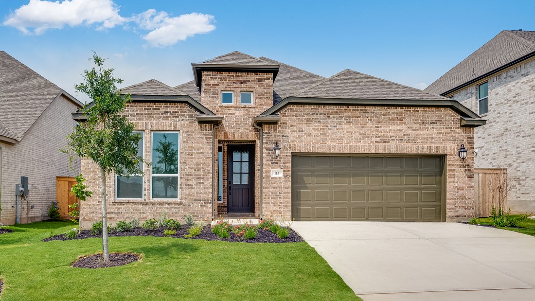 113 Golden Sage Avenue Georgetown, TX 78633 - Photo 1 of 1 a front view of a house with a garden and plants
