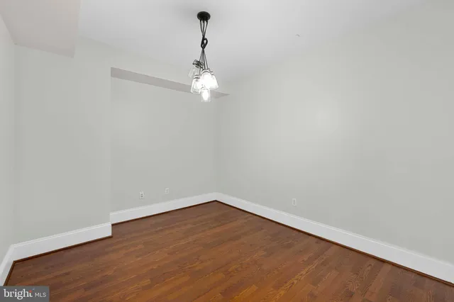 a view of a room with wooden floor and white wall