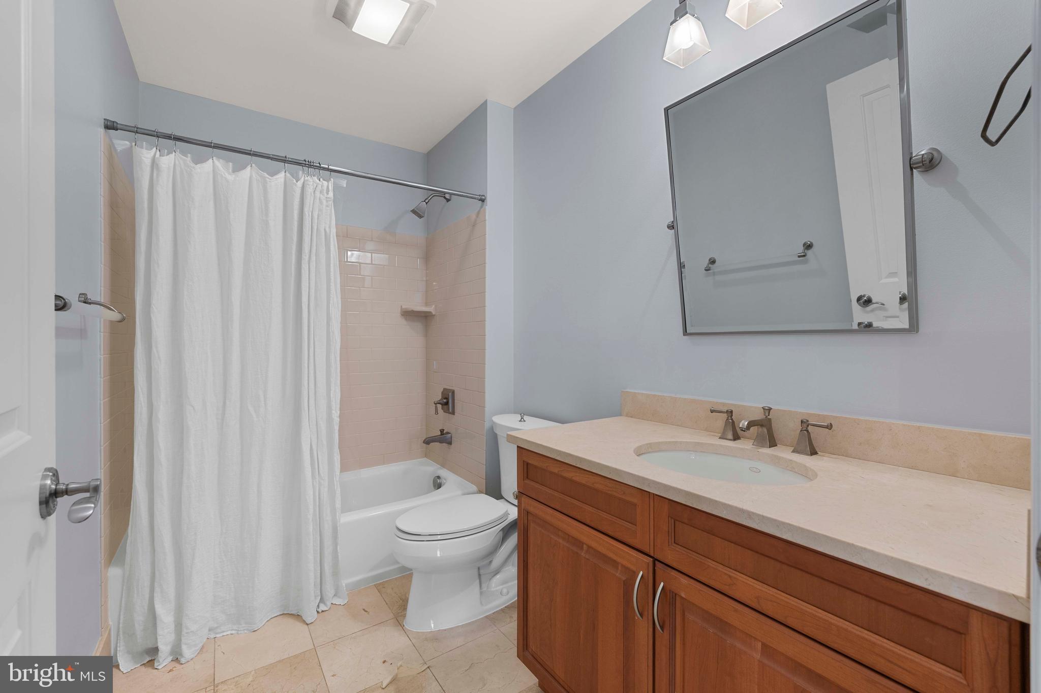 1830 Jefferson Place Northwest, Unit 12 Washington, DC 20036 - Photo 19 of 27 a bathroom with a sink a toilet and shower