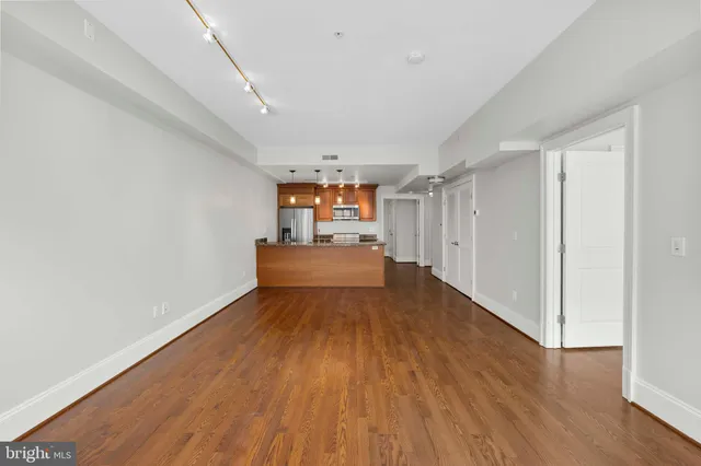 a view of a room with wooden floor