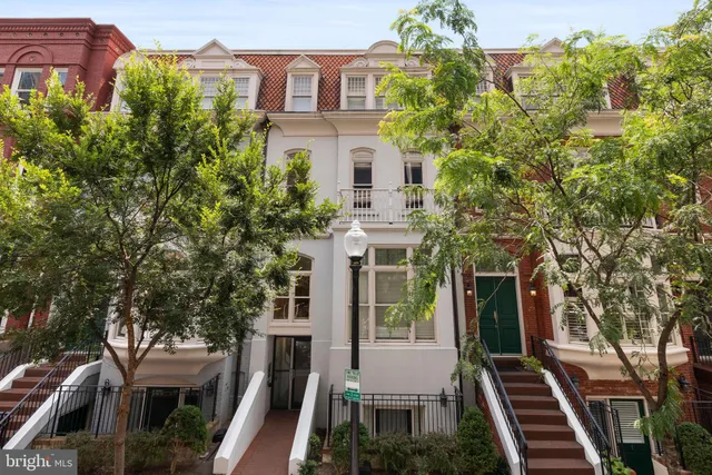 a front view of a residential houses with yard