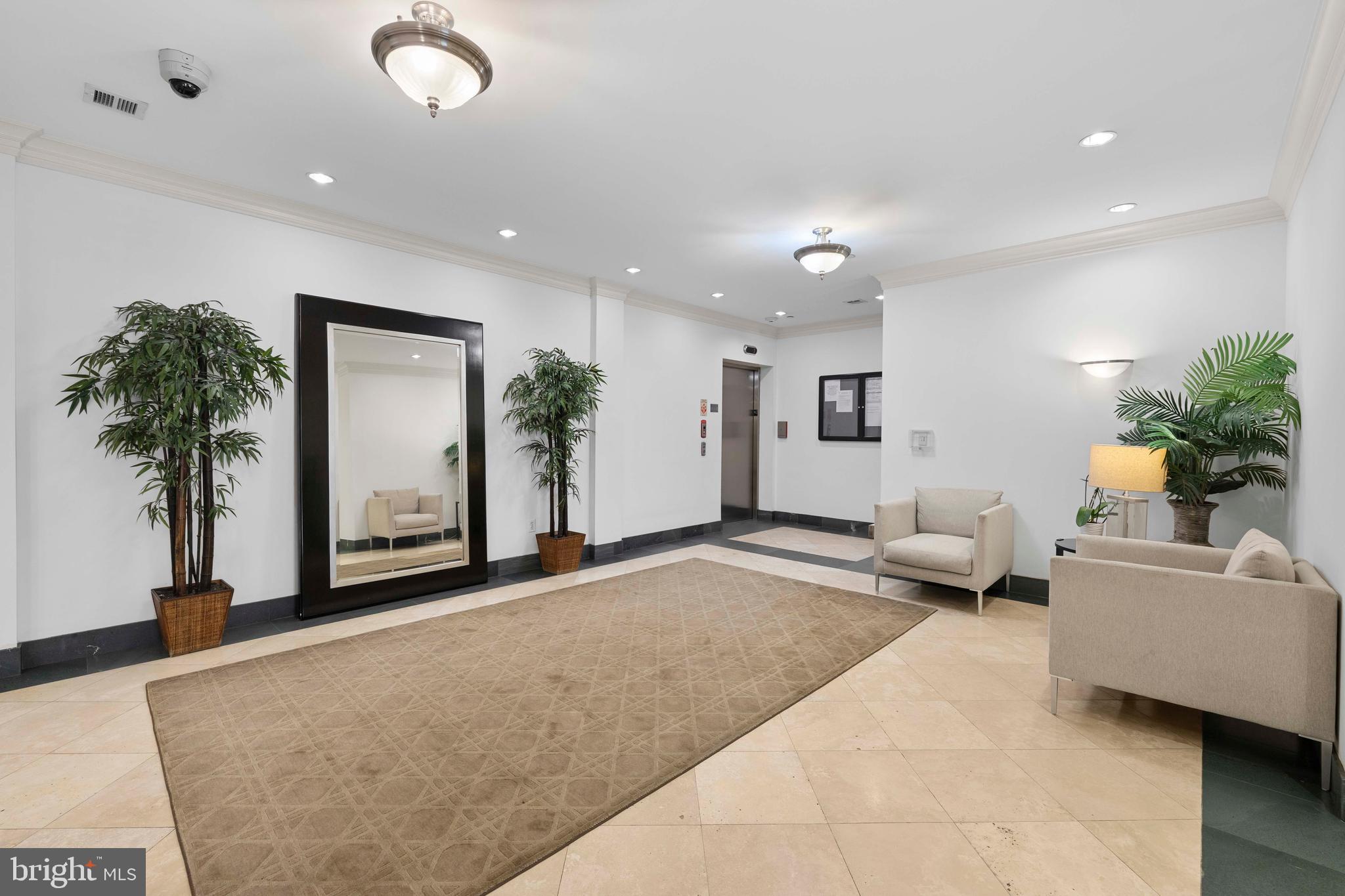 1830 Jefferson Place Northwest, Unit 12 Washington, DC 20036 - Photo 22 of 27 a living room with furniture and a potted plant