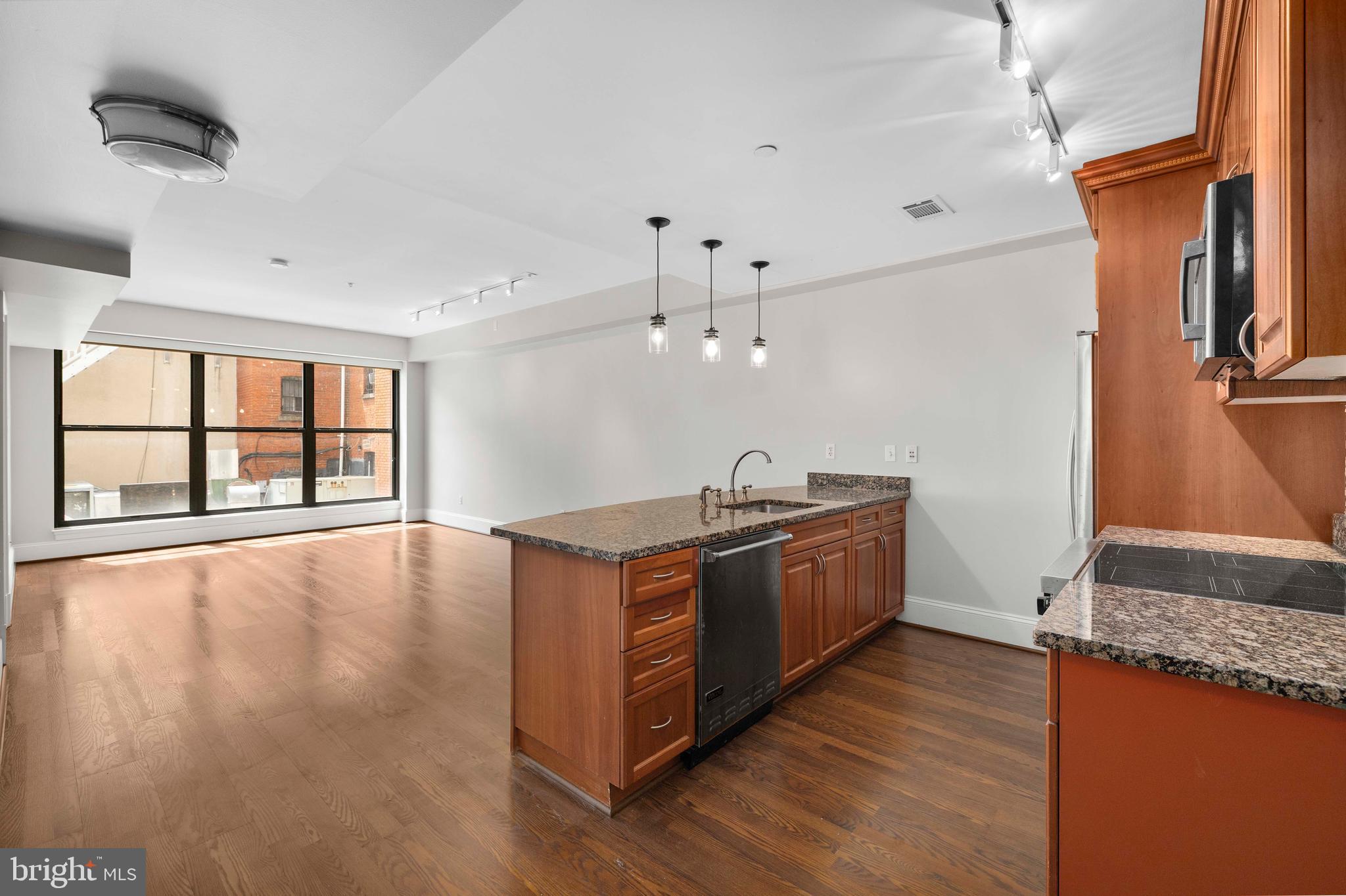1830 Jefferson Place Northwest, Unit 12 Washington, DC 20036 - Photo 6 of 27 a large kitchen with stainless steel appliances granite countertop a stove a sink and a large window