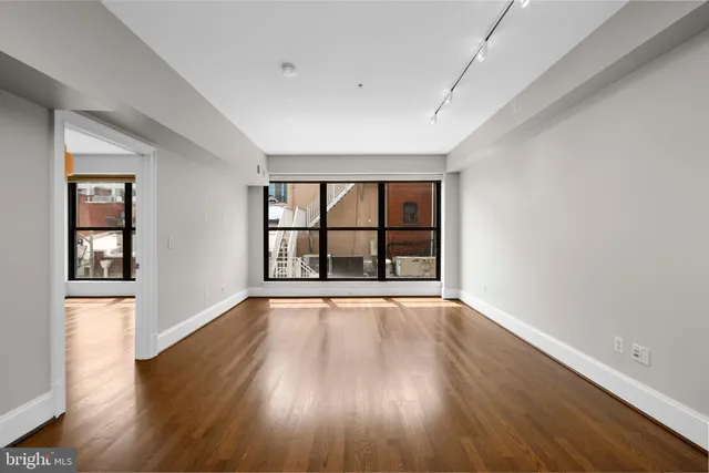 wooden floor in an empty room with a window