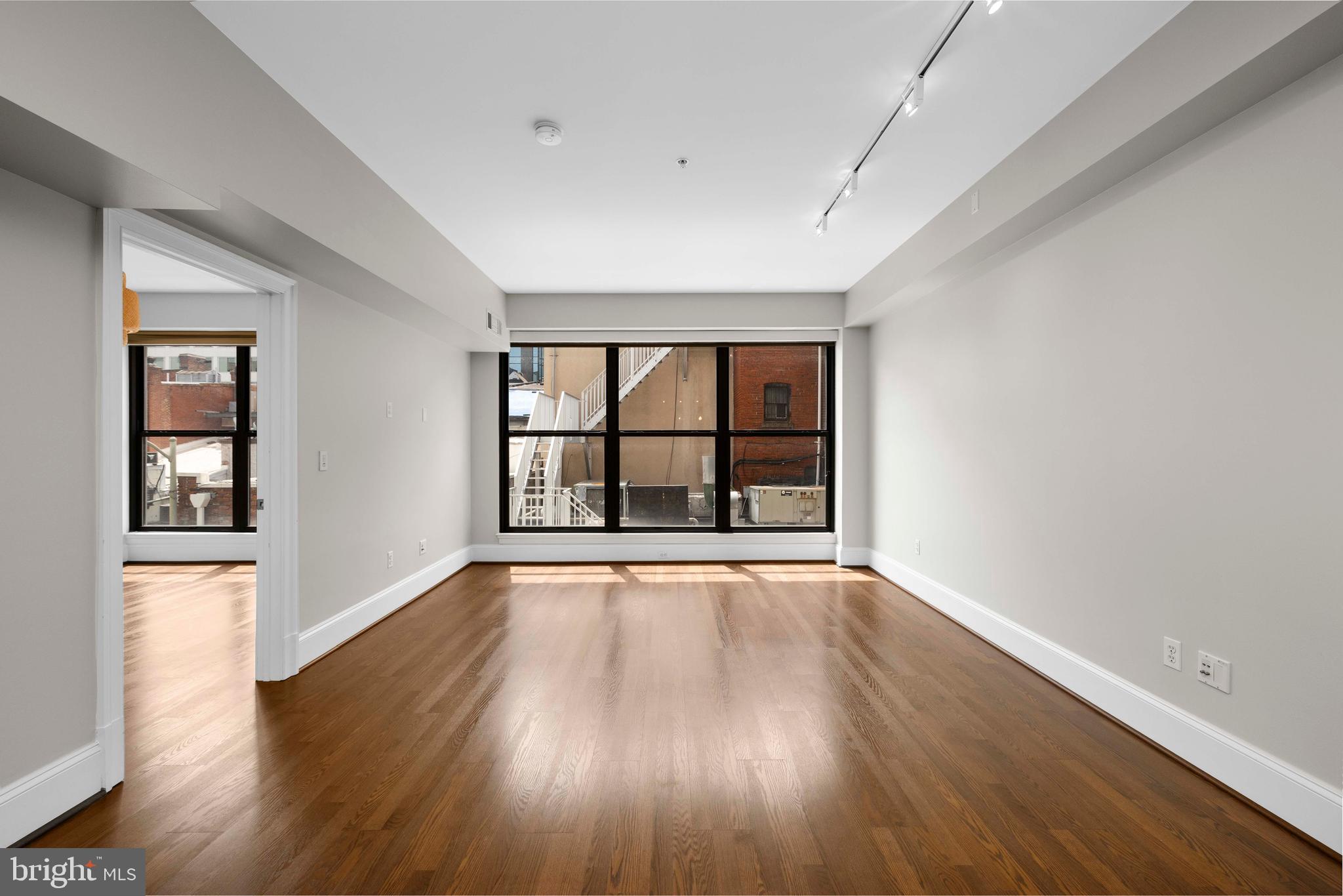 1830 Jefferson Place Northwest, Unit 12 Washington, DC 20036 - Photo 8 of 27 wooden floor in an empty room with a window
