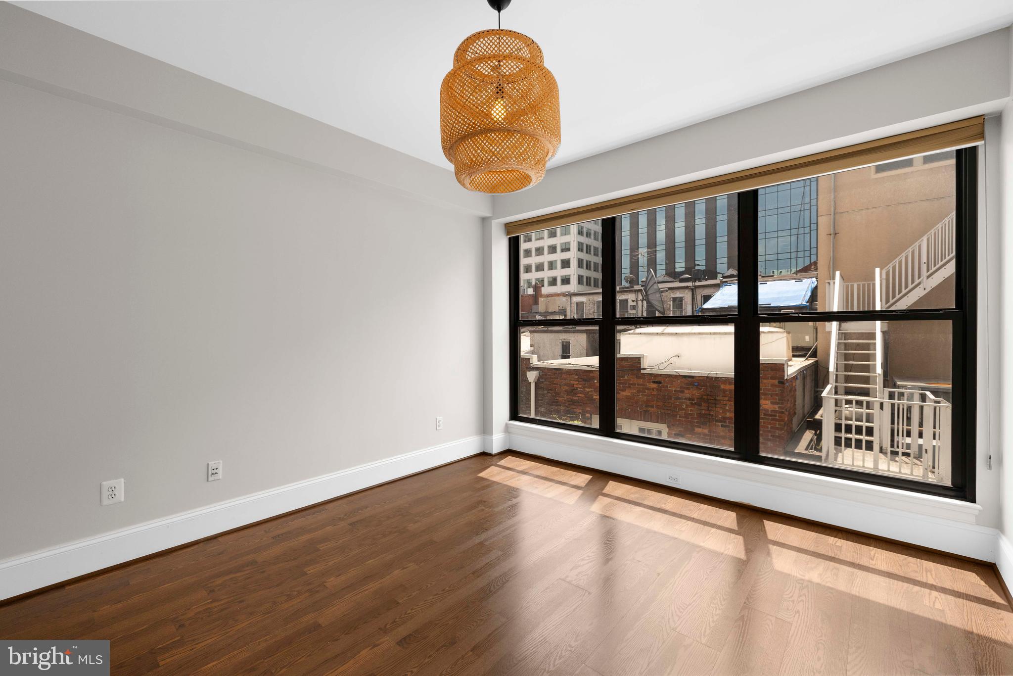 1830 Jefferson Place Northwest, Unit 12 Washington, DC 20036 - Photo 10 of 27 a room with window and a chandelier