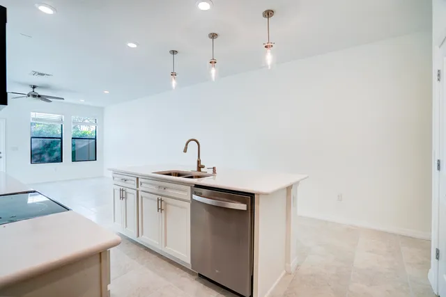 a kitchen with a sink a stove and a window