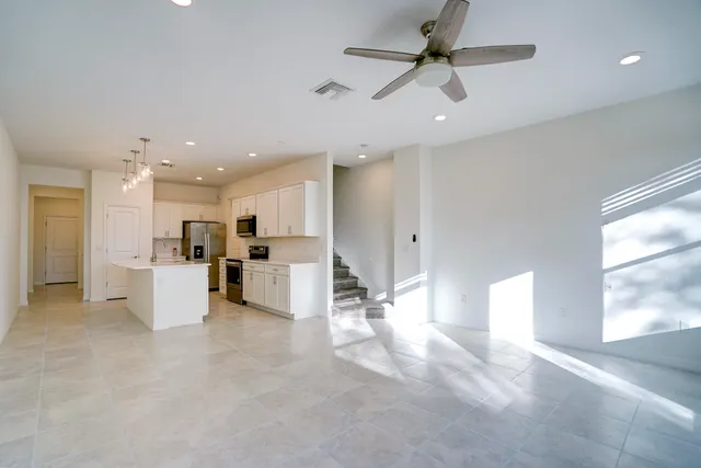 a view of kitchen with furniture and refrigerator