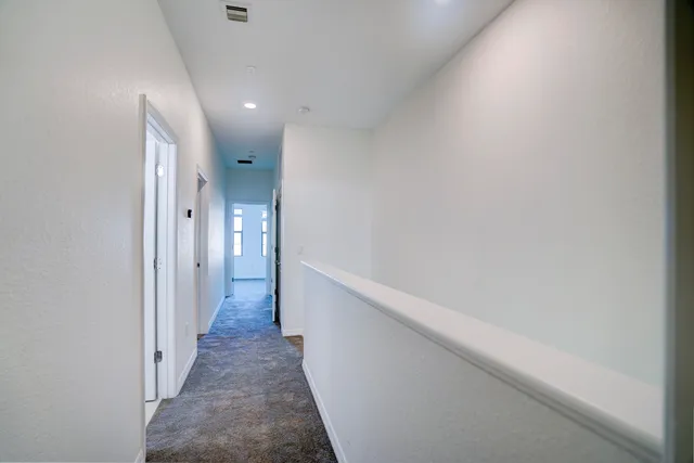 a view of a hallway with white walls