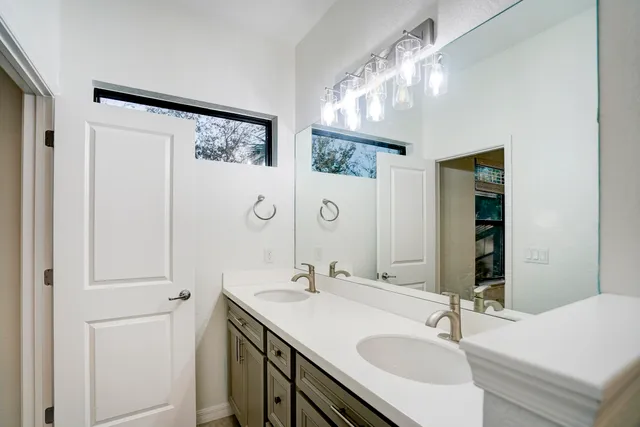 a bathroom with a sink double vanity and a mirror