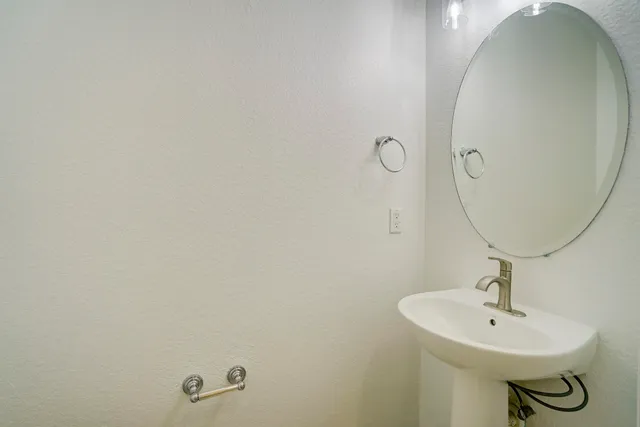 a bathroom with a sink and mirror