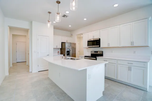 a kitchen with stainless steel appliances a stove sink and refrigerator
