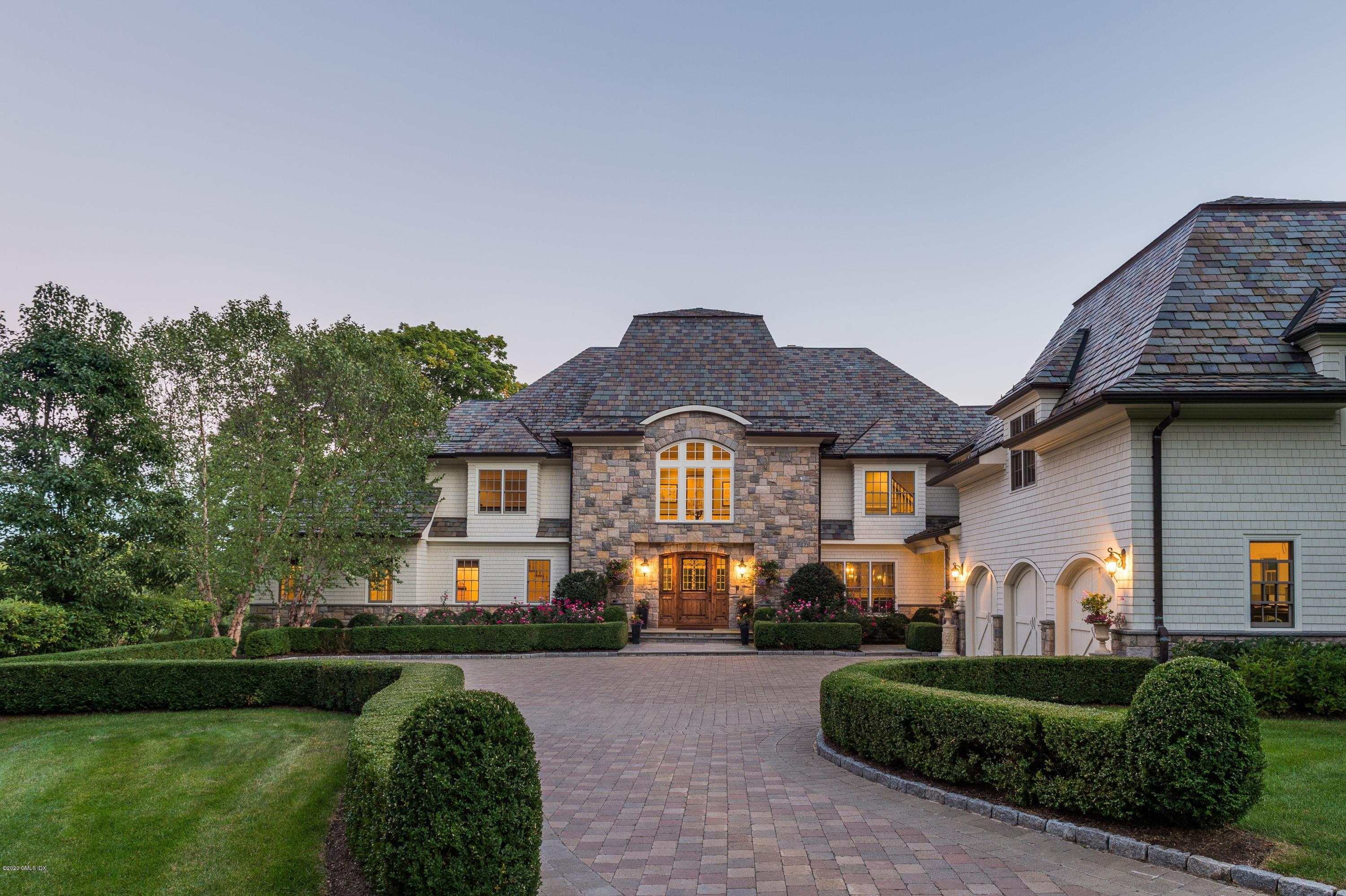 7 Chieftans Road Greenwich, CT 06831 - Photo 1 of 37 a front view of a house with garden