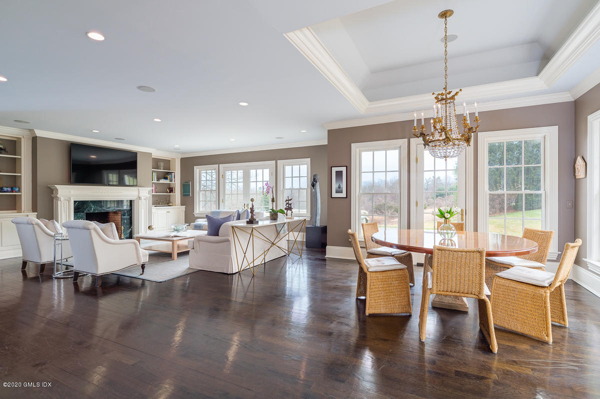 7 Chieftans Road Greenwich, CT 06831 - Photo 11 of 37 a living room with fireplace furniture and a chandelier