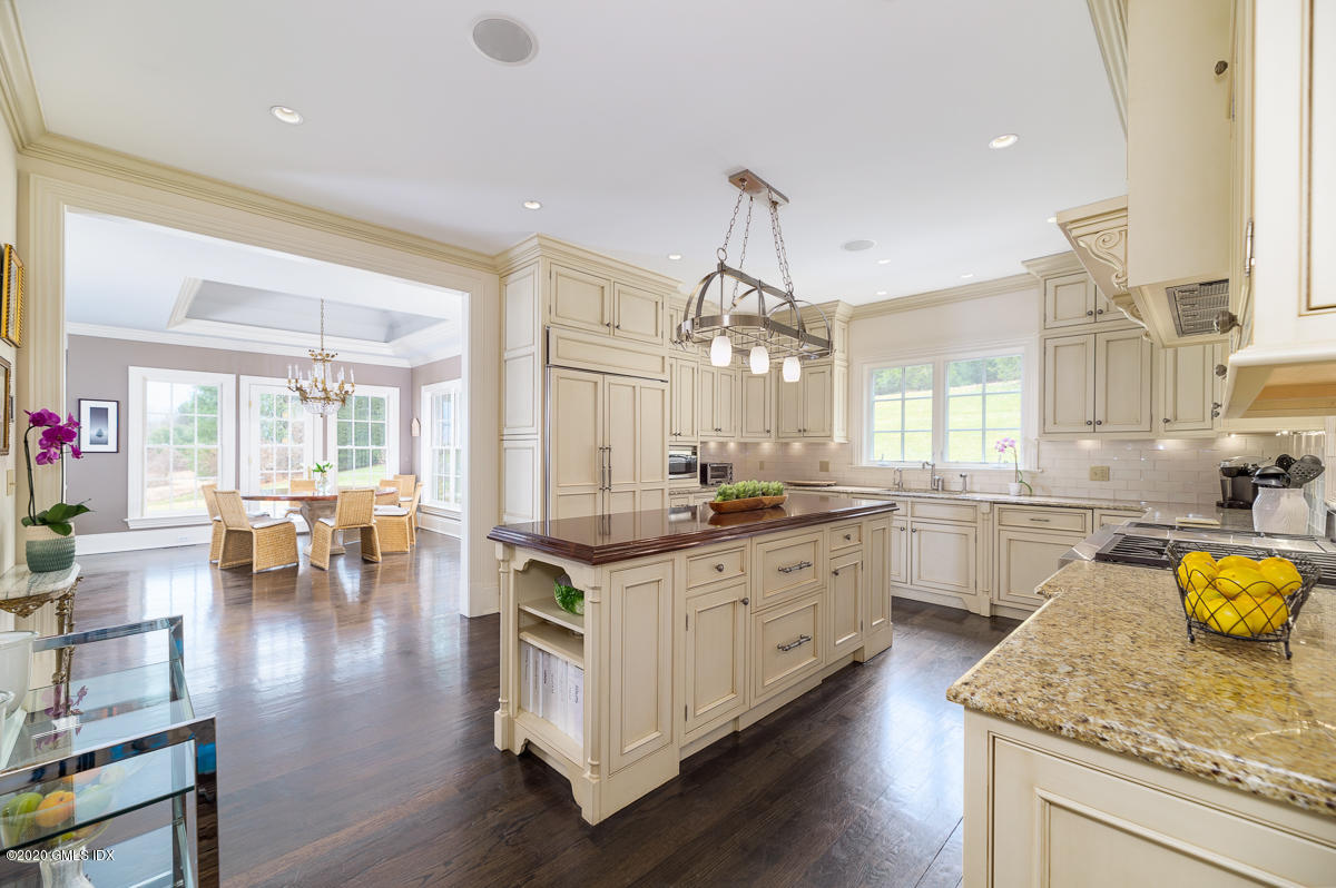 7 Chieftans Road Greenwich, CT 06831 - Photo 12 of 37 a large kitchen with kitchen island white cabinets and stainless steel appliances