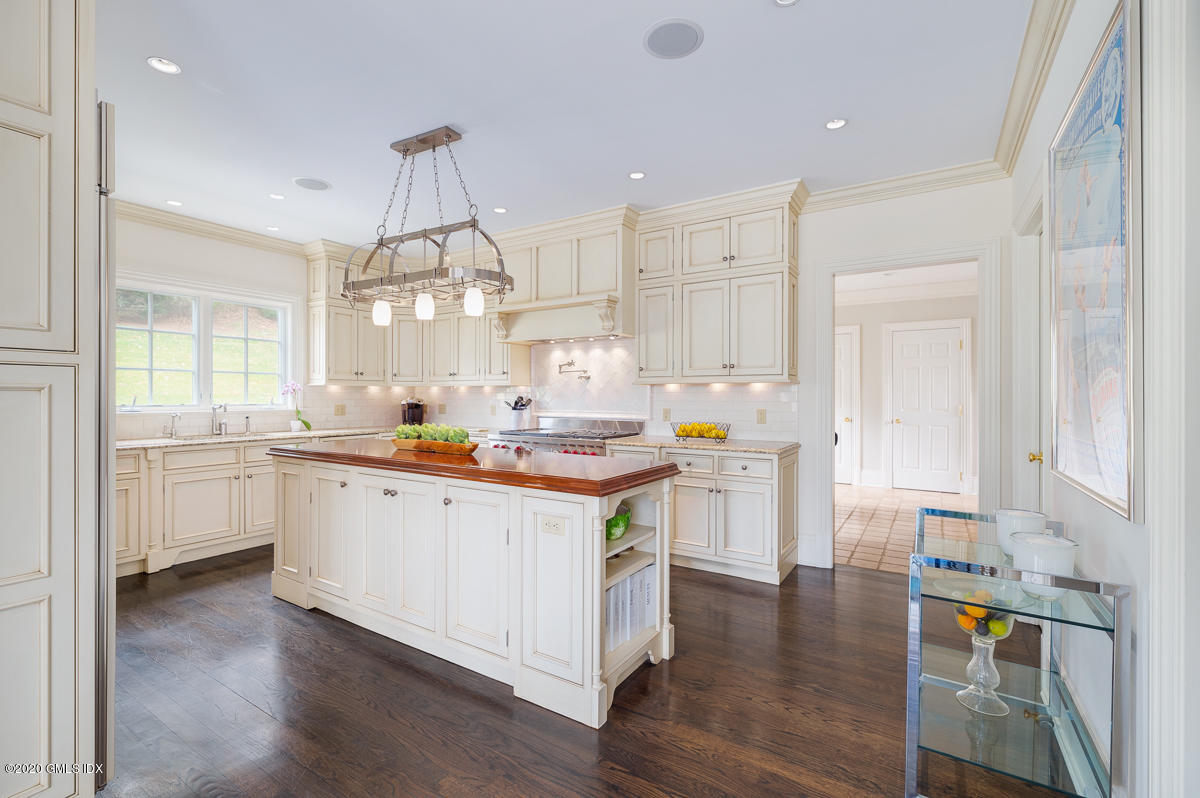 7 Chieftans Road Greenwich, CT 06831 - Photo 13 of 37 a kitchen with white cabinets and sink