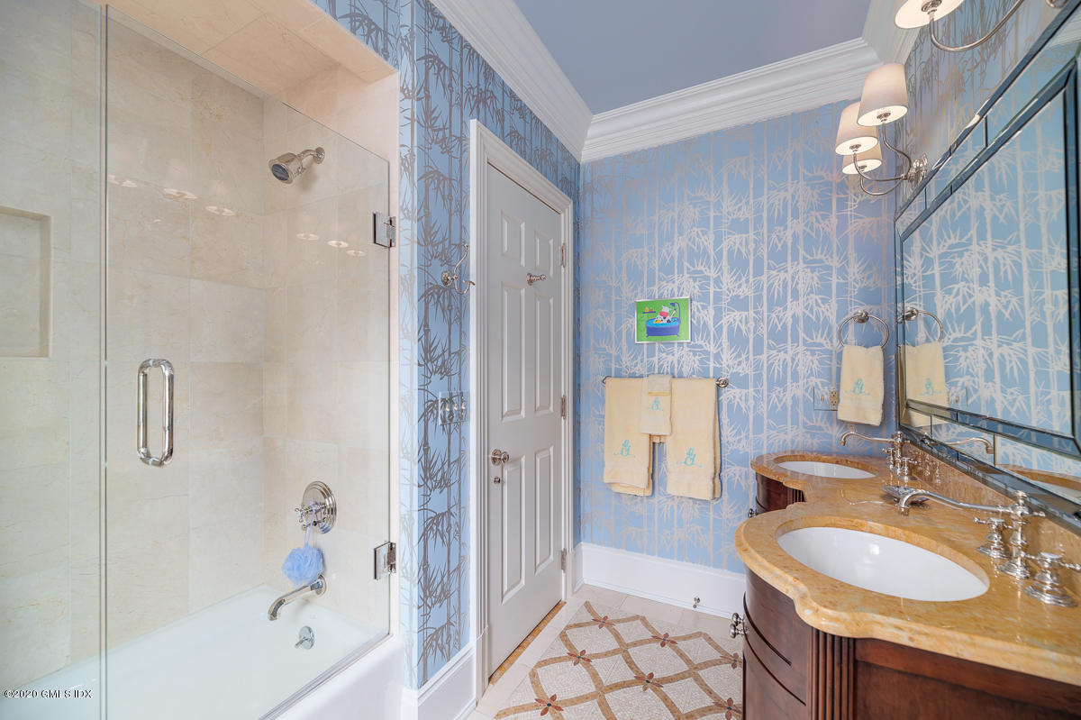 7 Chieftans Road Greenwich, CT 06831 - Photo 15 of 37 a bathroom with a sink double vanity mirror and a bathtub