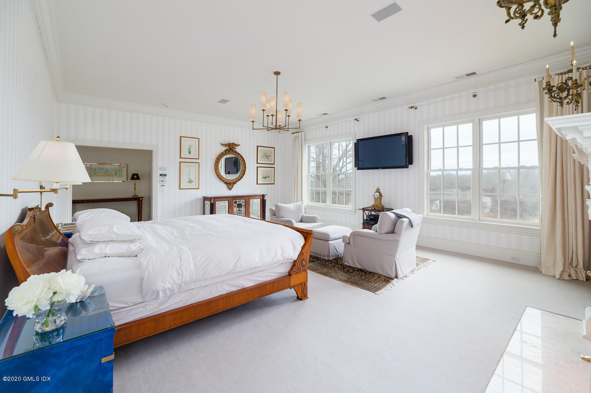 7 Chieftans Road Greenwich, CT 06831 - Photo 16 of 37 a spacious bedroom with a bed and a couch
