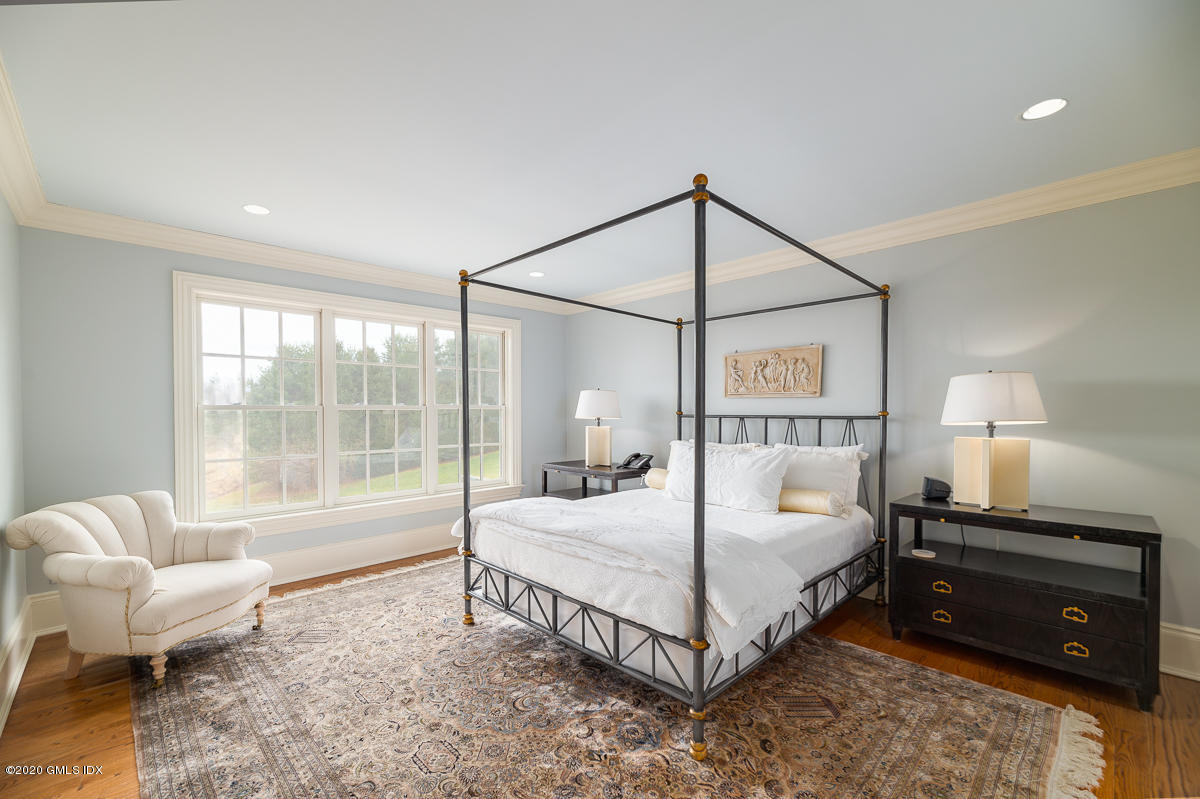 7 Chieftans Road Greenwich, CT 06831 - Photo 20 of 37 a bedroom with a bed and a large window