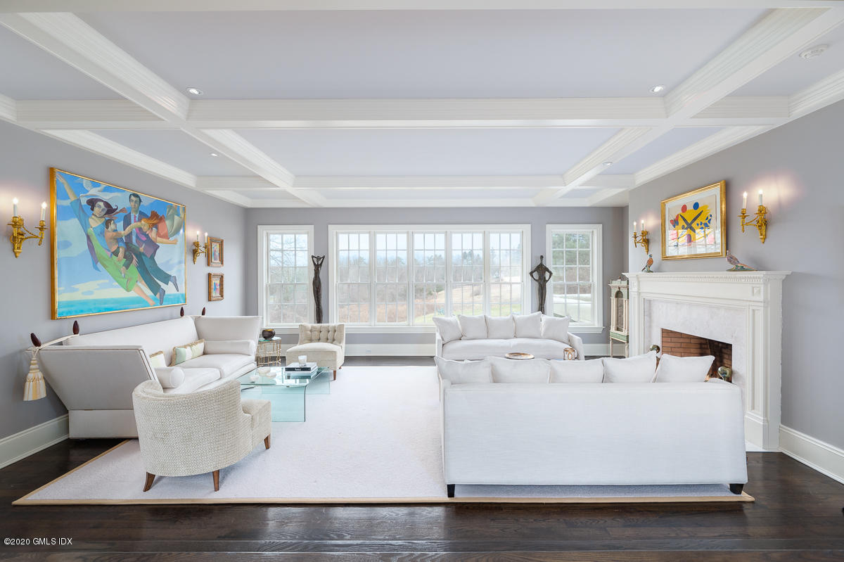 7 Chieftans Road Greenwich, CT 06831 - Photo 6 of 37 a living room with fireplace furniture and a large window