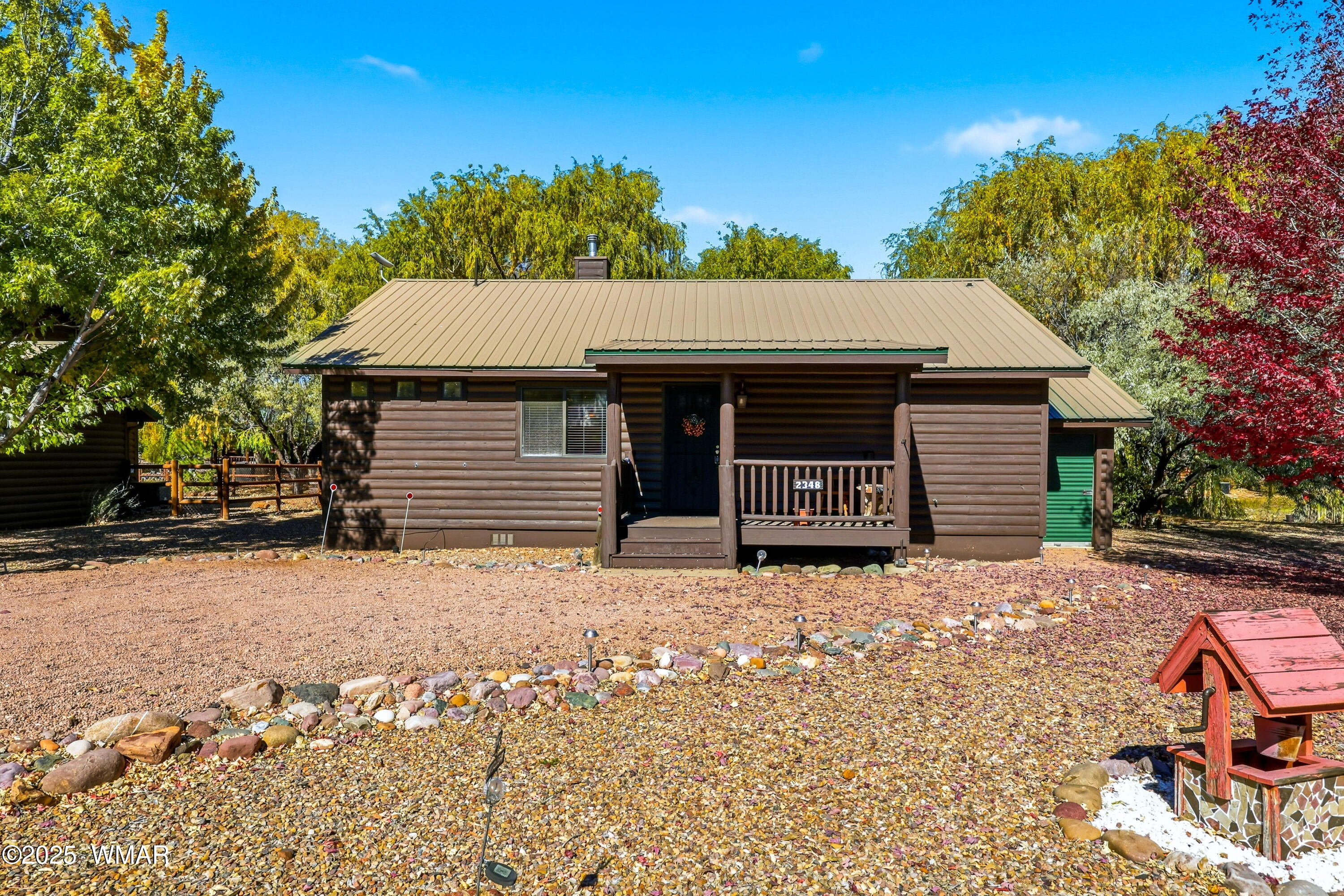 2348 South Buffalo Loop Overgaard, AZ 85933 - Photo 2 of 38 a front view of a house with a yard covered with snow