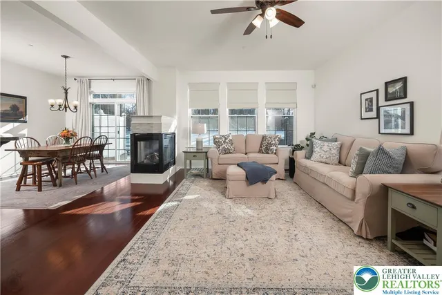 a living room with furniture fireplace and a table