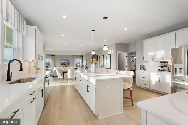 a kitchen with appliances a sink and cabinets