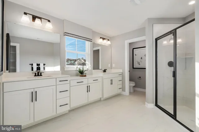 a spacious bathroom with double sink and a mirror
