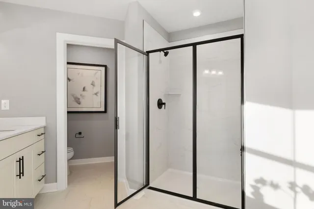 a bathroom with a shower sink and mirror