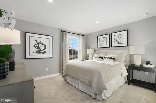 a bedroom with a bed and a painting on the wall