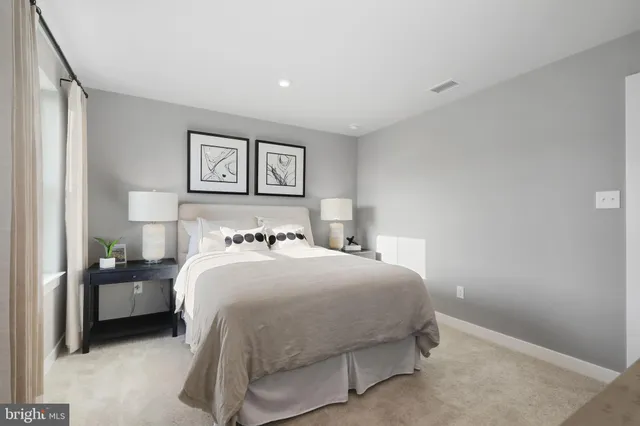 a bedroom with a bed and a painting on the wall