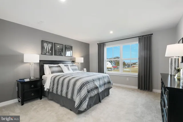 a spacious bedroom with a bed and a couch